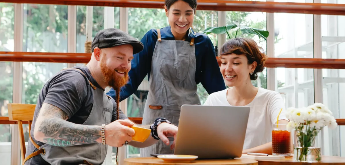 Friends showing referral on laptop