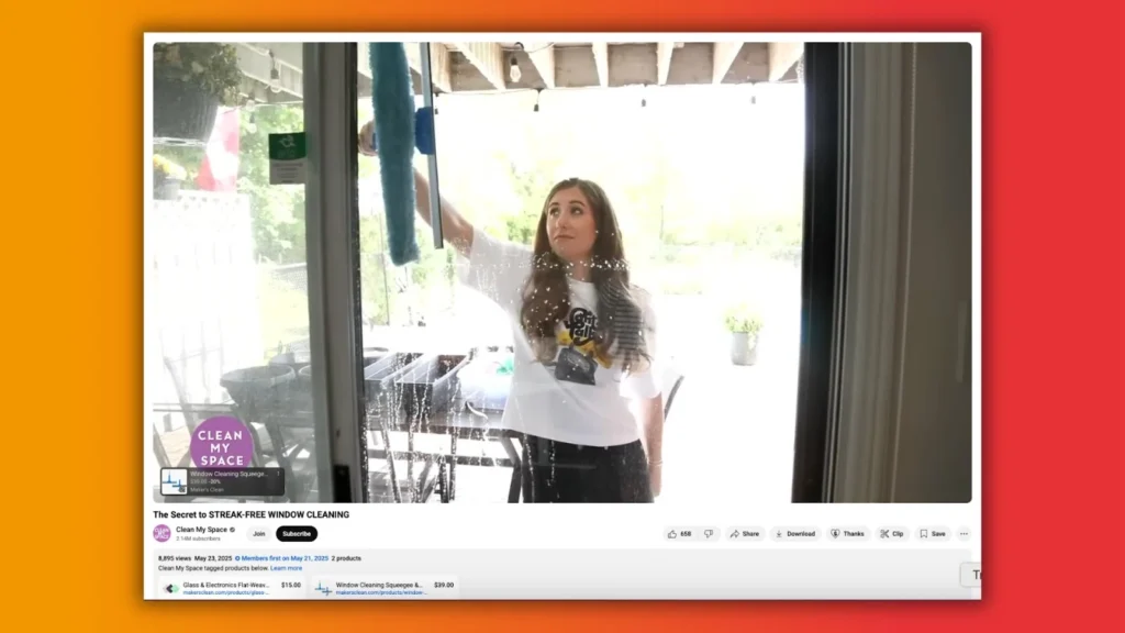 A person is cleaning a window with a blue squeegee, revealing a bright outdoor scene with potted plants and a patio table.