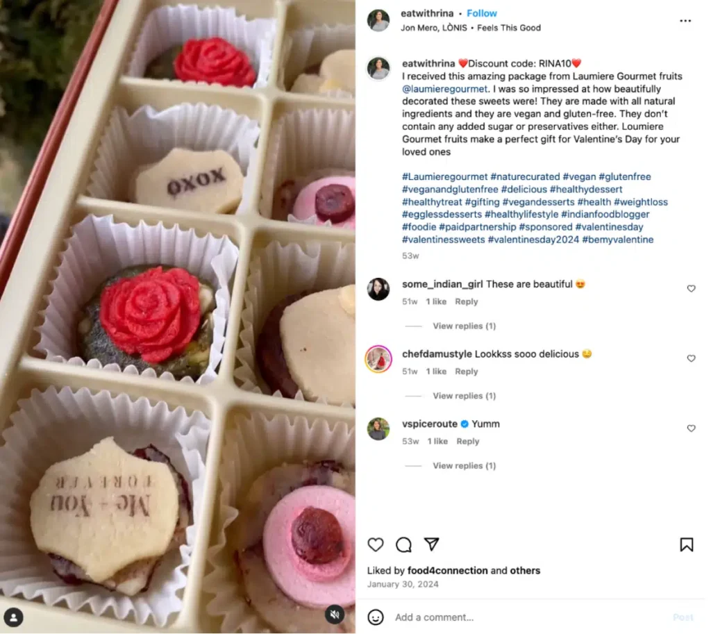 A close-up view of beautifully decorated vegan desserts in a gift box, featuring roses, hearts, and vibrant colors, perfect for Valentine's Day.