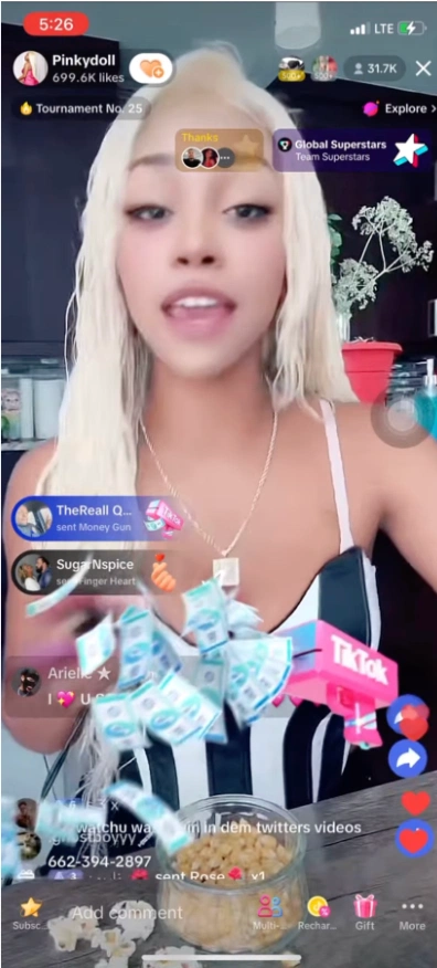 A person in a black and white striped outfit receiving animated money and gifts during a live streaming session with a bowl in front.