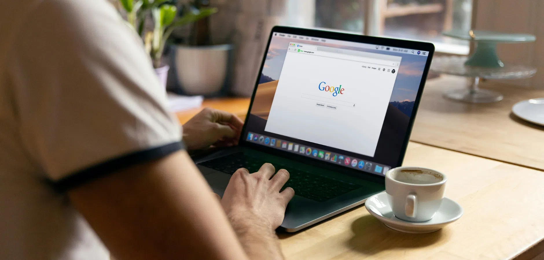 A man woking on his laptop with google open