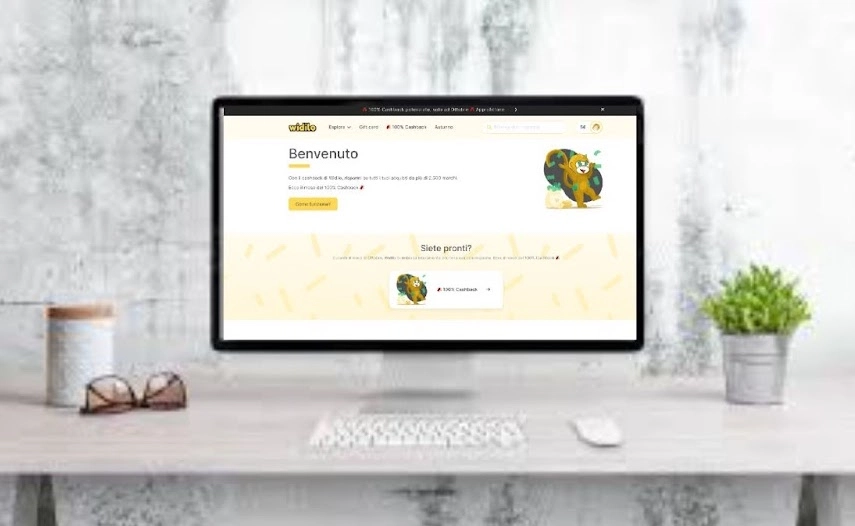 A desktop computer with a yellow bird perched on the monitor, creating a vibrant and lively workspace scene.