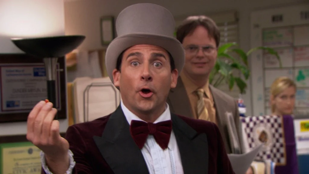 Michael Scott humorously engages with colleagues in the office setting, showcasing a lively workplace atmosphere.