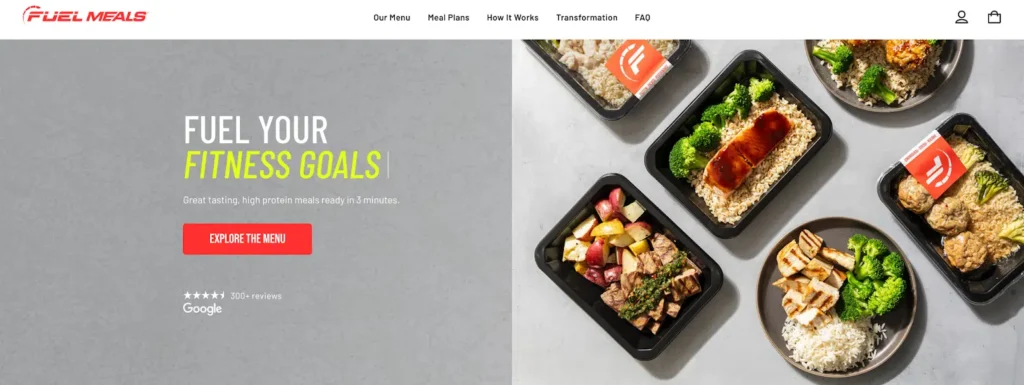 An assortment of healthy, high-protein meals in black containers, featuring chicken, rice, broccoli, and colorful sides.