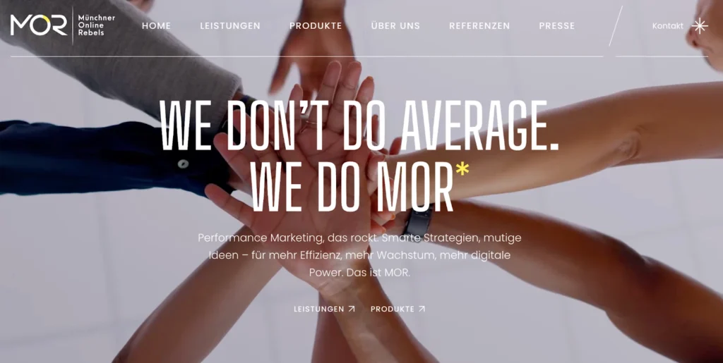 A diverse group of hands stacking in a teamwork gesture against a light background, emphasizing collaboration and creativity.