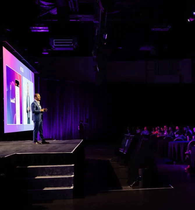 David Yovanno speaking on stage at iPX25