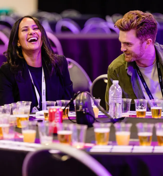 Guest laughing at table at iPX25