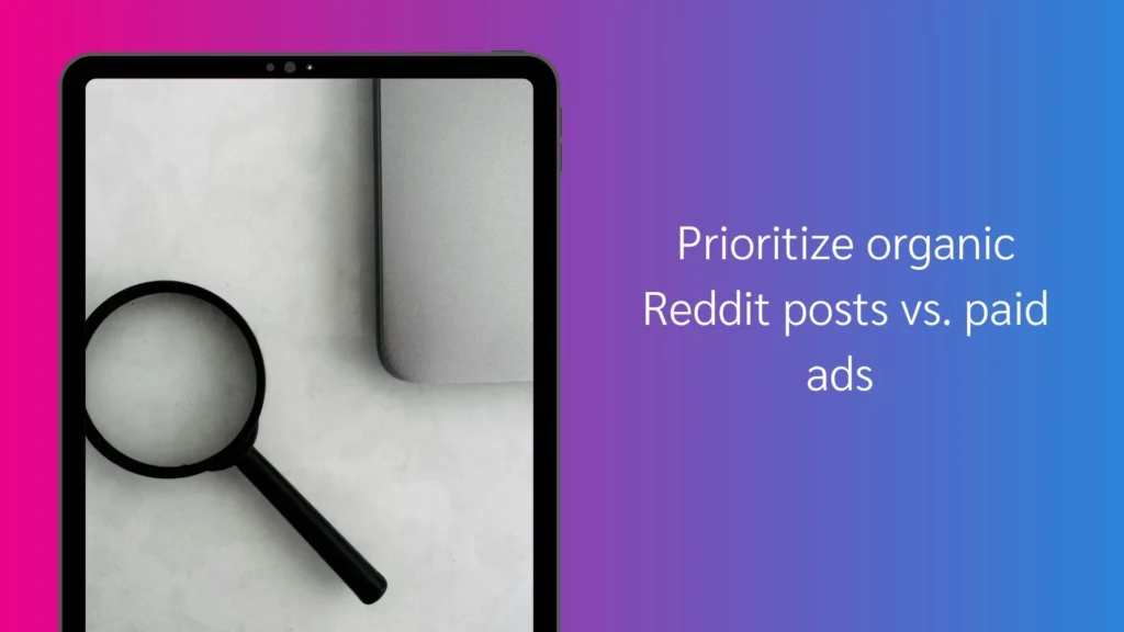 A magnifying glass rests on a white surface next to a laptop, with text emphasizing prioritizing organic Reddit posts over paid ads.