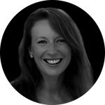 A woman with long, dark hair is centered in a circular frame against a dark background.